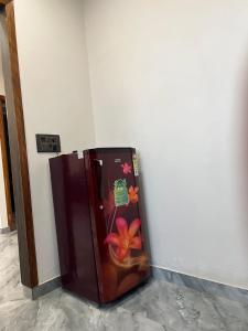 a brown refrigerator with flowers on the side of a wall at Starlight villa in Ghaziabad