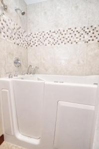 a bathroom with a white tub and a sink at Annabell Gardens in Lincoln