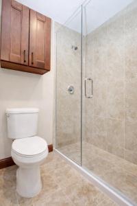 a bathroom with a toilet and a glass shower at Annabell Gardens in Lincoln