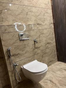 a bathroom with a toilet and a shower at Starlight villa in Ghaziabad +17 photos