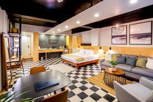 a hotel room with a bed and a couch at Joint Boutique Hotel in Puerto Vallarta