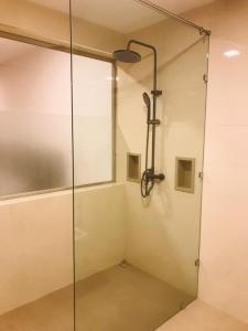 a shower in a bathroom with a glass door at REEF VIEW Beach Hotel in Matara