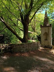 a park with a bench and a tree and a tower at The Snug self contained apartment in Killyleagh