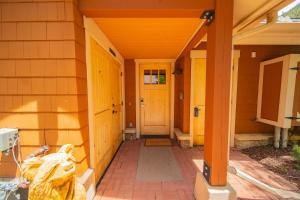 a front porch of a house with yellow doors at Settlers Creek 6514 by SummitCove Lodging in Colorado in Keystone