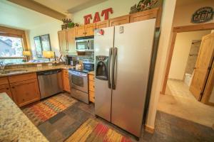 a kitchen with a large stainless steel refrigerator at Settlers Creek 6514 by SummitCove Lodging in Colorado in Keystone +42 photos