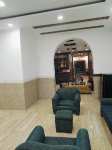 a lobby with couches and chairs in a room at Green Haven Farm & Events in Bhundsi
