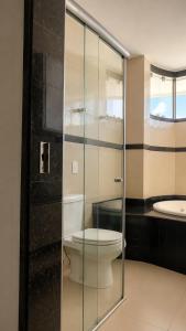 a bathroom with a toilet and a sink at Hotel Residence in Caruaru +10 photos