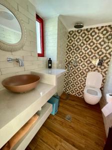 a bathroom with a sink and a toilet at Ahiri traditional cottage in Galatás +27 photos