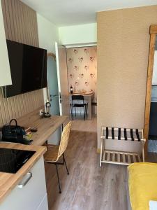 a living room with a desk and a dining room at L'Escale d'Armorique 1 in Languidic +8 photos