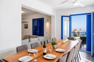 a dining room with a table and chairs and a couch at Villa Eagles Nest in Pachyammos