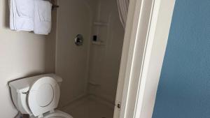 a bathroom with a white toilet and a shower at Atlantic Crest Inn and Suites in Myrtle Beach