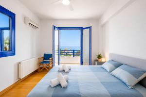 a bedroom with a large bed with a view of the ocean at Villa Eagles Nest in Pachyammos +14 photos