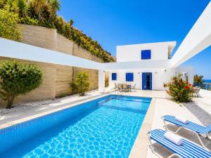 a swimming pool in the backyard of a villa at Villa Eagles Nest in Pachyammos
