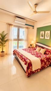 a bedroom with a large bed and a window at Sylevo 2bhk kharadi in Pune