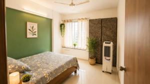 a bedroom with a bed and a window and a radiator at Sylevo 2bhk kharadi in Pune