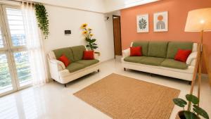 a living room with two chairs and a couch at Sylevo 2bhk kharadi in Pune