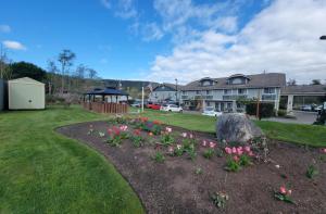 a garden with flowers and a gazebo in a yard at Fidalgo Country Inn in Anacortes