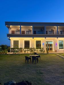 a large building with a table in front of it at Foreste Resort in Rāmnagar