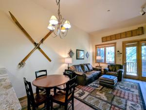 a living room with a table and a couch at Arapahoe Lodge 8105 by SummitCove Lodging in Colorado in Keystone +54 photos