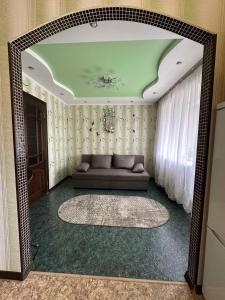a living room with a couch in a room at Central Comfort in Konotop