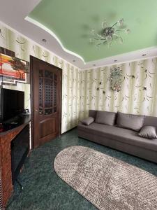 a living room with a couch and a television at Central Comfort in Konotop