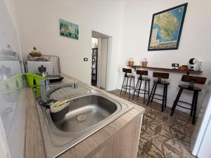 a kitchen with a stainless steel sink and a counter at Aquarius Salento in Acquarica del Capo +42 photos
