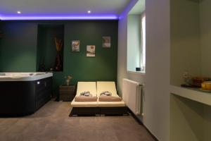 a bathroom with a tub and a bed and a bath tub at Hotel al Dòs - Breakfast & Private SPA in Trento +61 photos