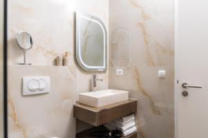 a bathroom with a sink and a mirror at White House Radac Peja in Peje +37 photos