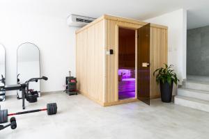 a gym with a wooden stall with a treadmill at White House Radac Peja in Peje