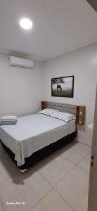 a bedroom with a bed with a picture on the wall at hOTEL CALIFORNIA in Barreiras
