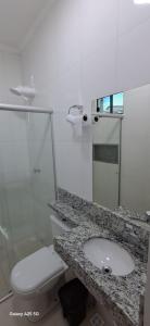 a white bathroom with a sink and a toilet at hOTEL CALIFORNIA in Barreiras
