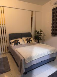 a bedroom with a bed with flowers on it at klebang Beachfront Homestay I Snooker I Massage Chair I Pool in Malacca