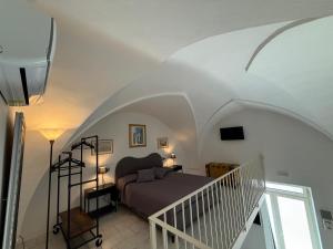 a bedroom with a bed and a staircase in a room at Aquarius Salento in Acquarica del Capo