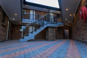 a building with a staircase and a brick wall at Kunjalo Lodge in Inadan