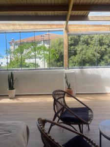 a room with a chair and a table and windows at Syrah Home in Tangier +66 photos