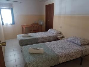 a room with three beds and a table and a window at Guara-Altaoja-Yaso in Yaso +24 photos