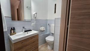 a bathroom with a white sink and a toilet at Janva Guest House in Sciacca +15 photos