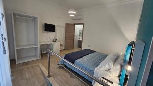 a hospital room with a bed and a television at Janva Guest House in Sciacca