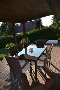 a table and chairs on a wooden deck at Sweet Home in Příchovice