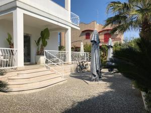 a house with two umbrellas on the front of it at B&B Numero Uno in Bisceglie
