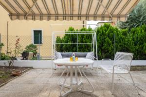 a white table and two chairs on a patio at Jolly Private Room in Marghera