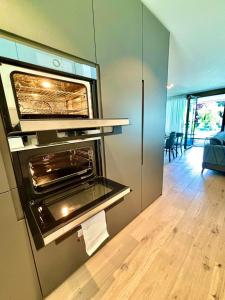 a kitchen with an oven in the wall at Heyko Holiday Interlaken in Interlaken