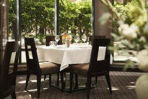 a table with chairs and a white table cloth on it at L'Hermitage Hotel in Vancouver