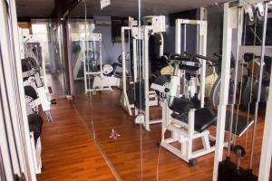 a gym with lots of equipment in a room at Paris Suites in Festac Town
