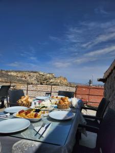 a table with plates of food on it with a view at MMF cave house in Nevşehir