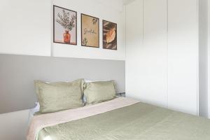 a bedroom with a bed with four pictures on the wall at Full Apartment with Pool and Gym - M1605 in Recife +41 photos
