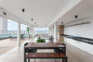 a room with a table and benches in a building at Full Apartment with Pool and Gym - M1605 in Recife
