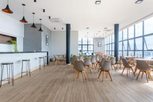 a restaurant with chairs and tables and a bar at Full Apartment with Pool and Gym - M1605 in Recife