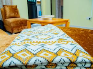 a blanket on top of a table with a chair at Umoja Backpacker's Stay in Msaranga