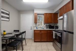 a kitchen with wooden cabinets and a table with chairs at Silver Springs Retreat in Silver Springs